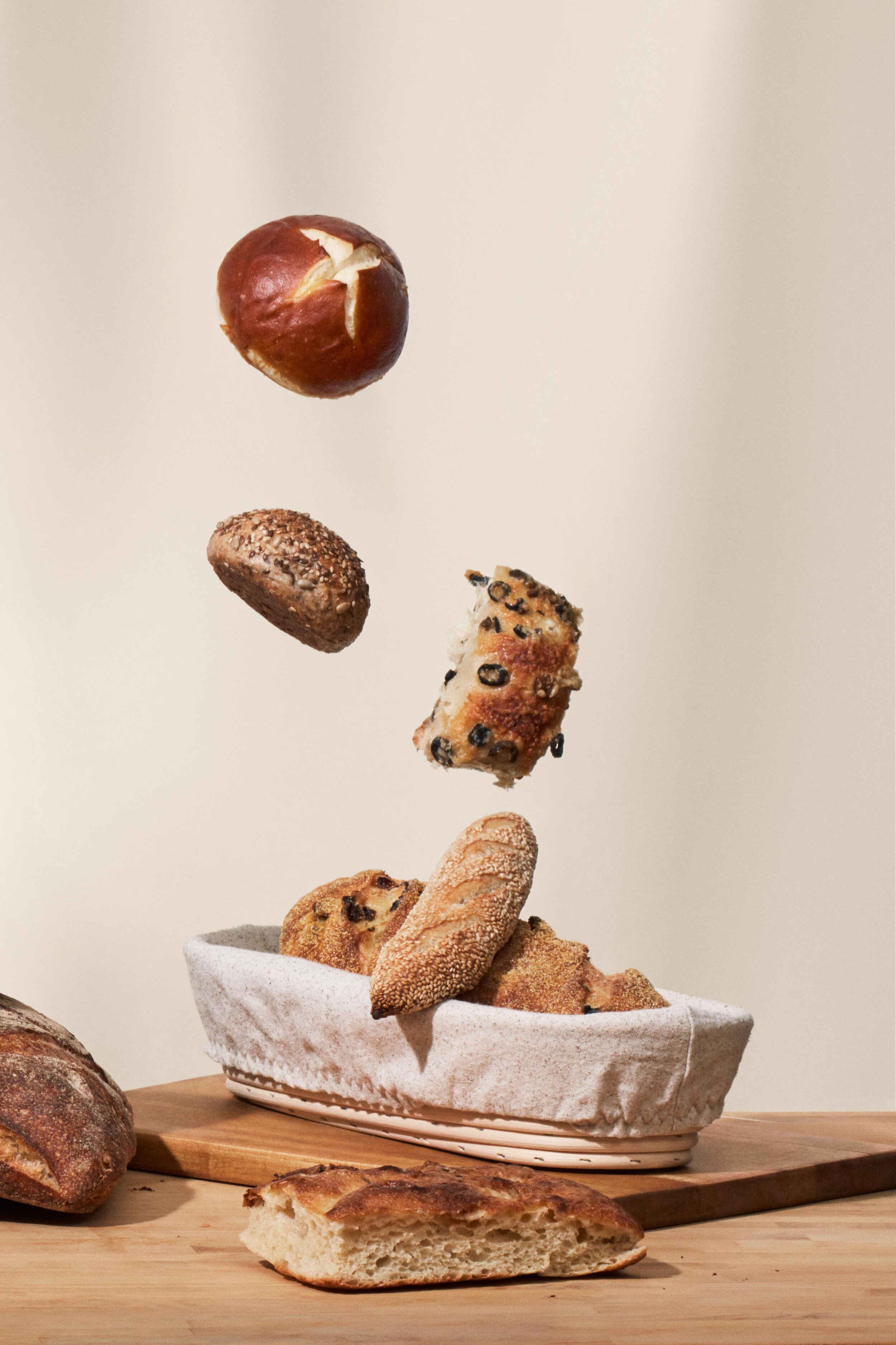 Array of baked goods falling into basket.